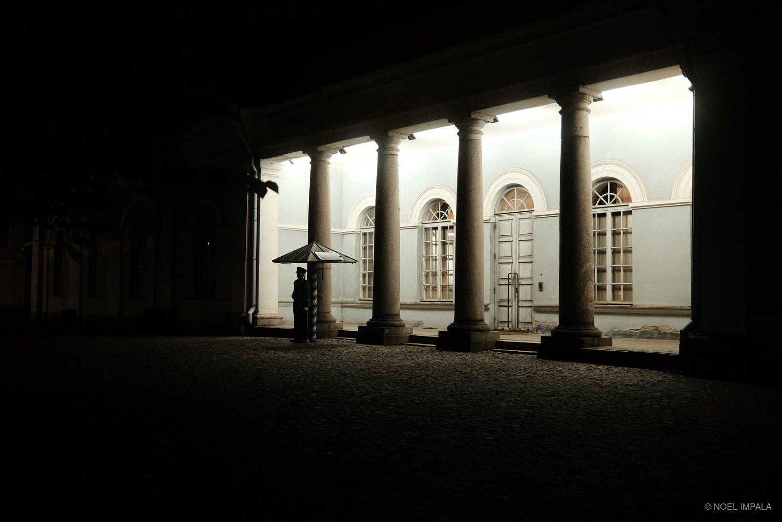 Illuminated colonnade at night