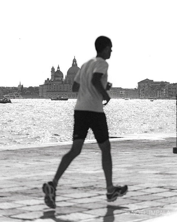 Runner jogging along Venice waterfront