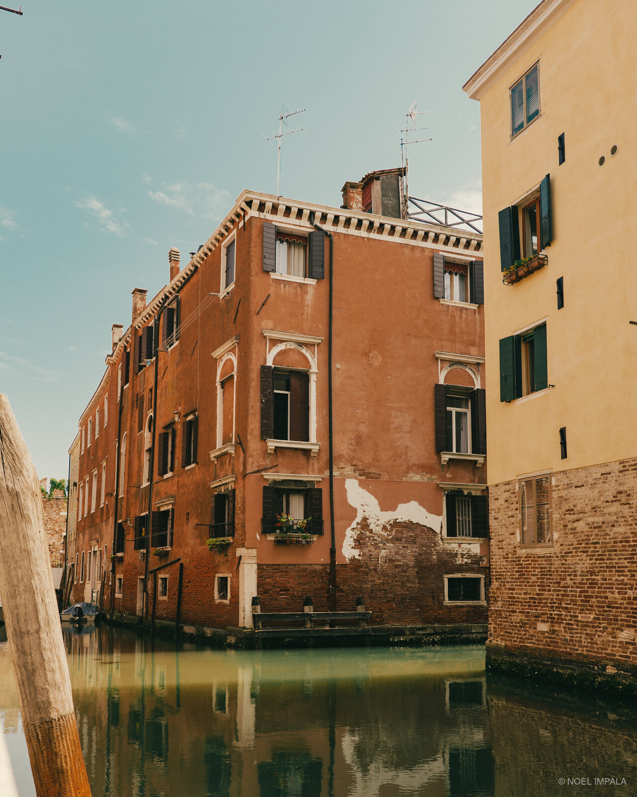 Red building reflected in Venice canal