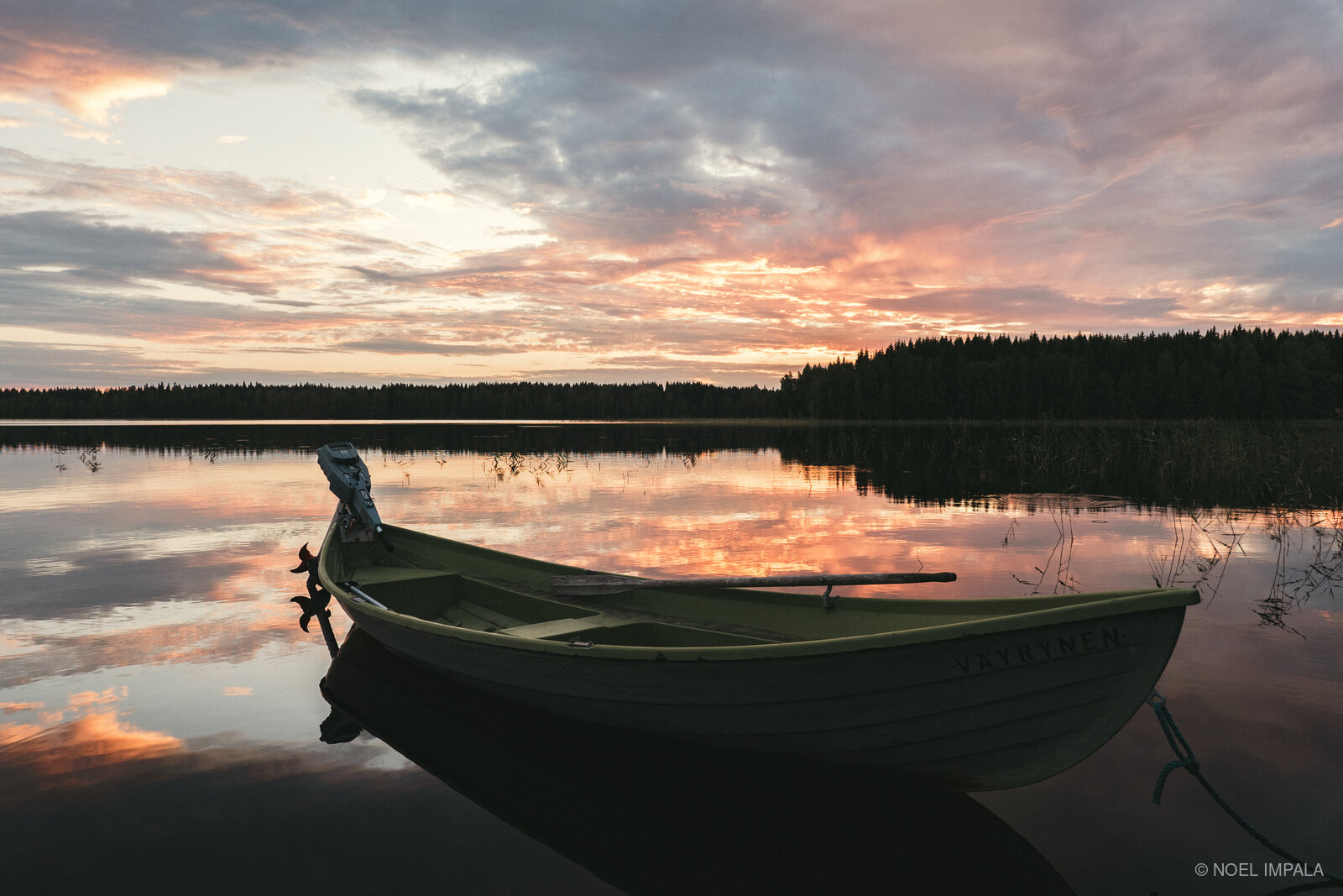 Boat on Finnish lake at sunset